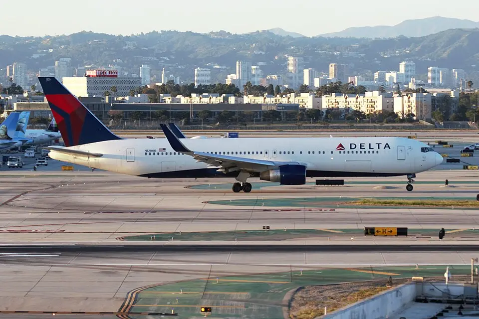 Delta Air Lines Boeing 767 taxiing at Los Angeles International Airport, with the city skyline in the background